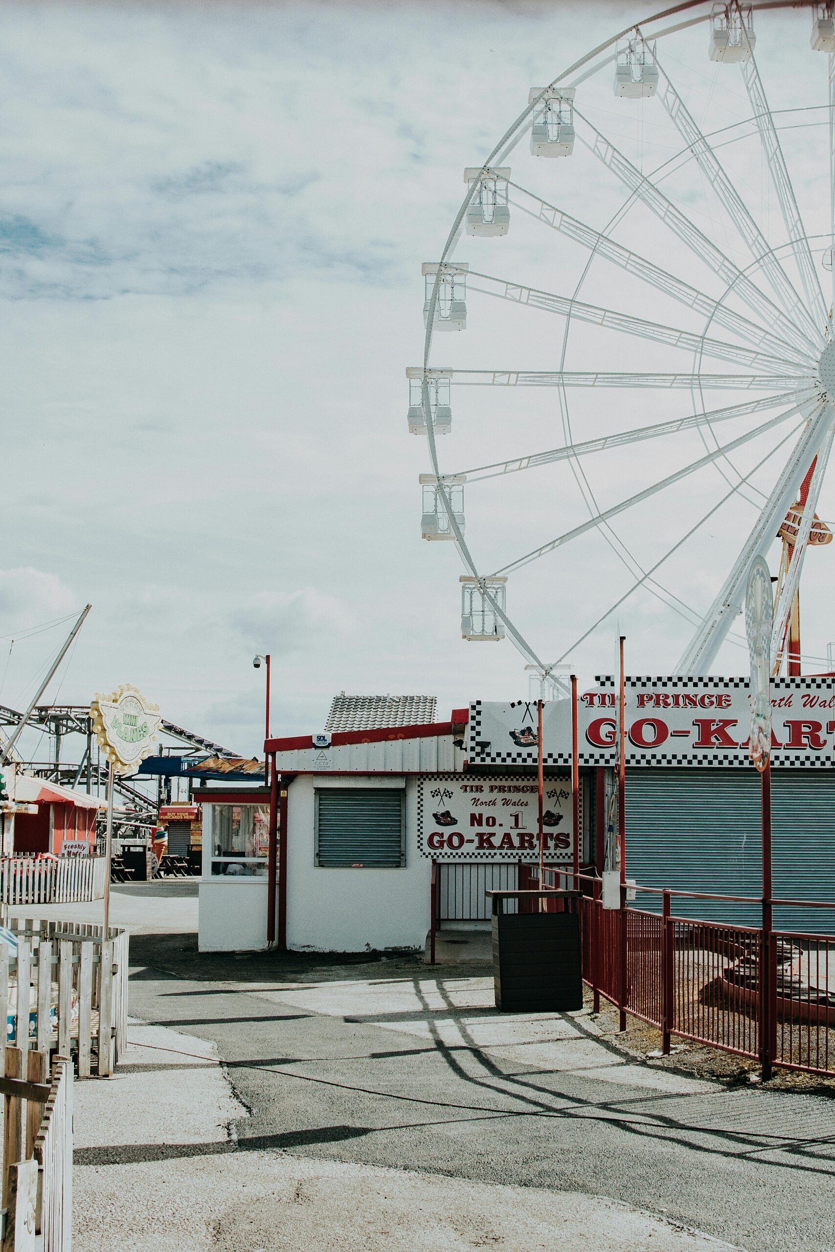 Ferris wheel and go-kart track at an amusement park in Rhyl, Wales.