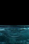 Abstract image of water ripple in dark minimalist setting, perfect for backgrounds.